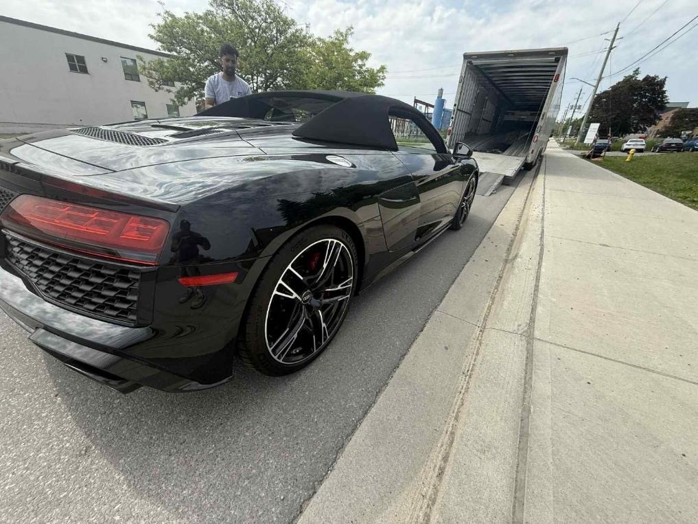 Luxury Car With Good Resale Value Being Loaded in Truck